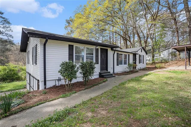 a backyard of a house with yard and outdoor seating