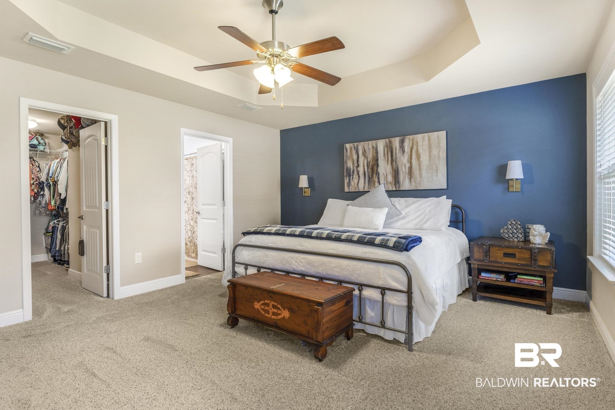 22043 Garland Loop Silverhill, AL 36576 - Photo 20 of 41 Bedroom featuring a walk in closet, light carpet, a tray ceiling, a ceiling fan, and connected bathroom