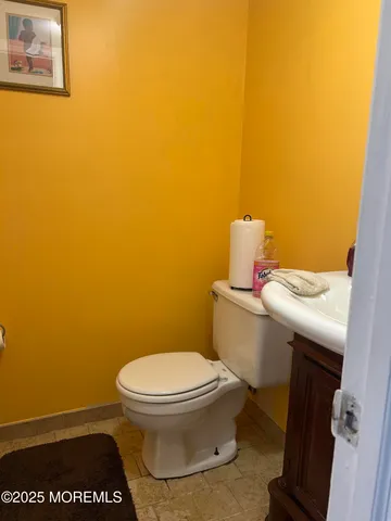 a bathroom with a toilet and a vanity