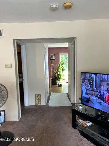 a view of furniture and paintings on the wall