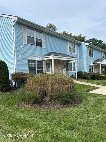 a view of a house with a backyard