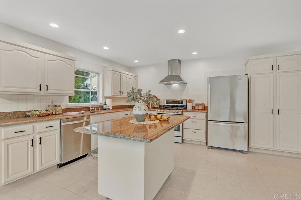 340 Trailview Road Encinitas, CA 92024 - Photo 16 of 35 a kitchen with granite countertop refrigerator sink and cabinets