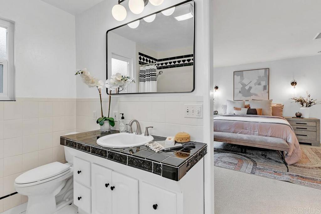 340 Trailview Road Encinitas, CA 92024 - Photo 24 of 35 a bathroom with a sink a toilet and a mirror