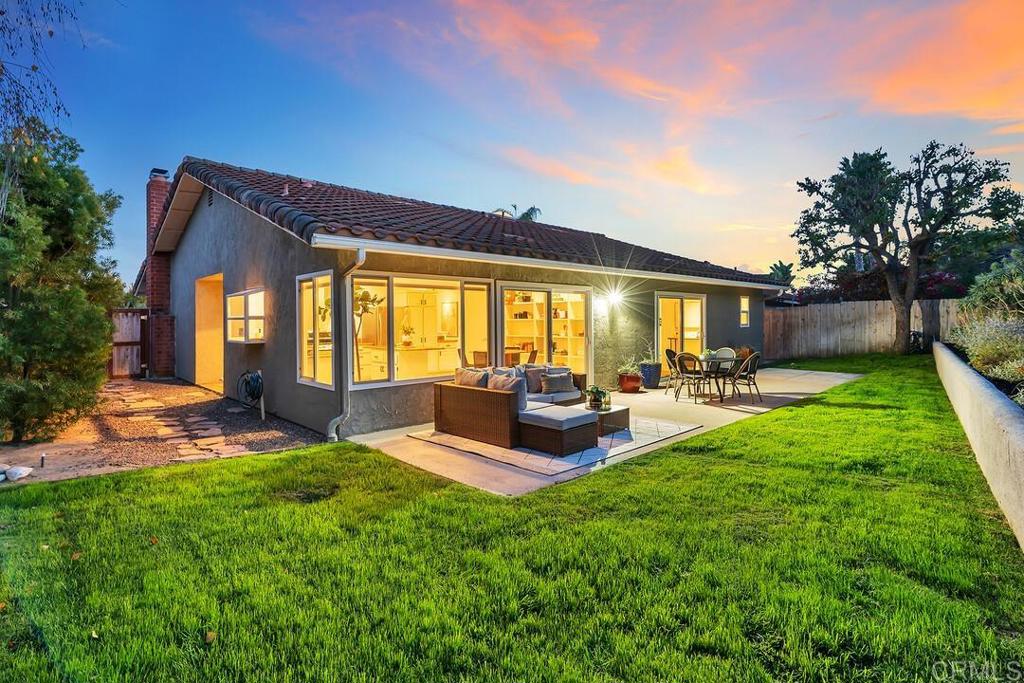 340 Trailview Road Encinitas, CA 92024 - Photo 27 of 35 a view of a patio with table and chairs potted plants and large tree