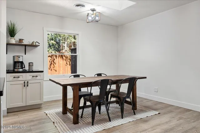a view of a dining room with furniture and a chandelier