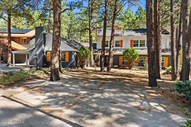 a view of a house with a tree in front