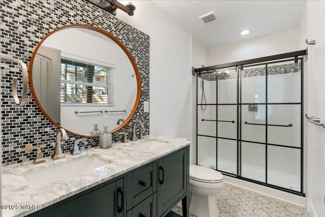 a bathroom with a toilet a sink and mirror