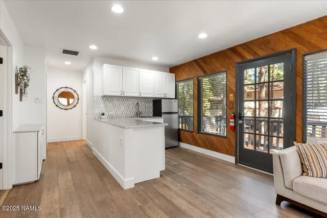 a kitchen with a refrigerator and a sink