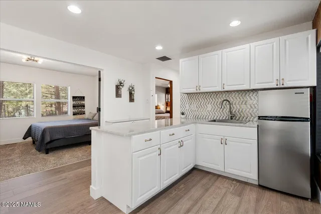 a kitchen with a refrigerator and a sink