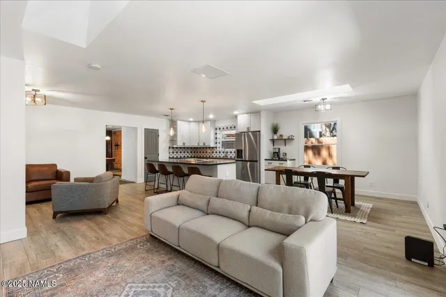 a living room with furniture and kitchen view