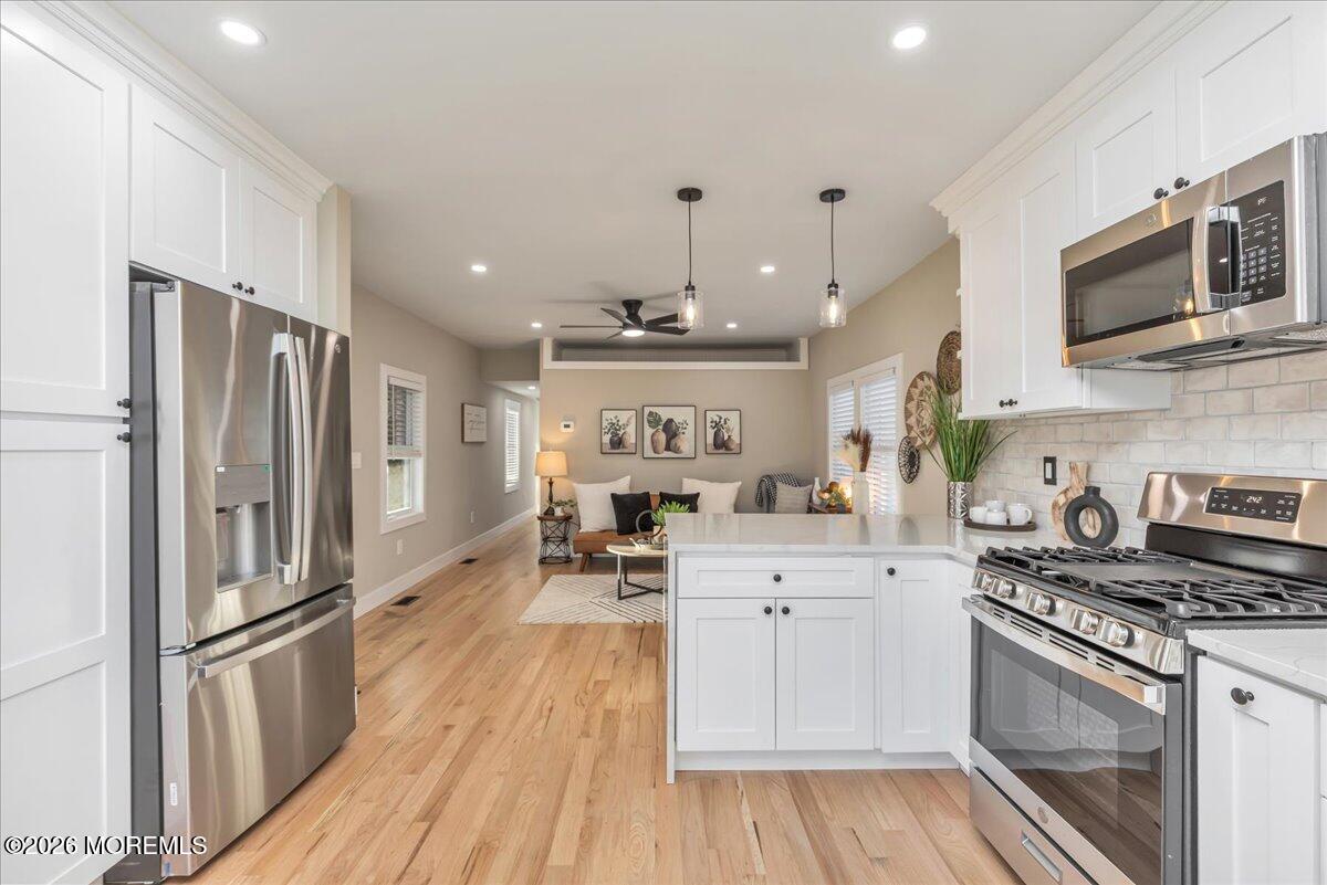 58 Locust Grove Hazlet, NJ 07730 - Photo 12 of 30 a kitchen with stainless steel appliances a stove a refrigerator and a sink