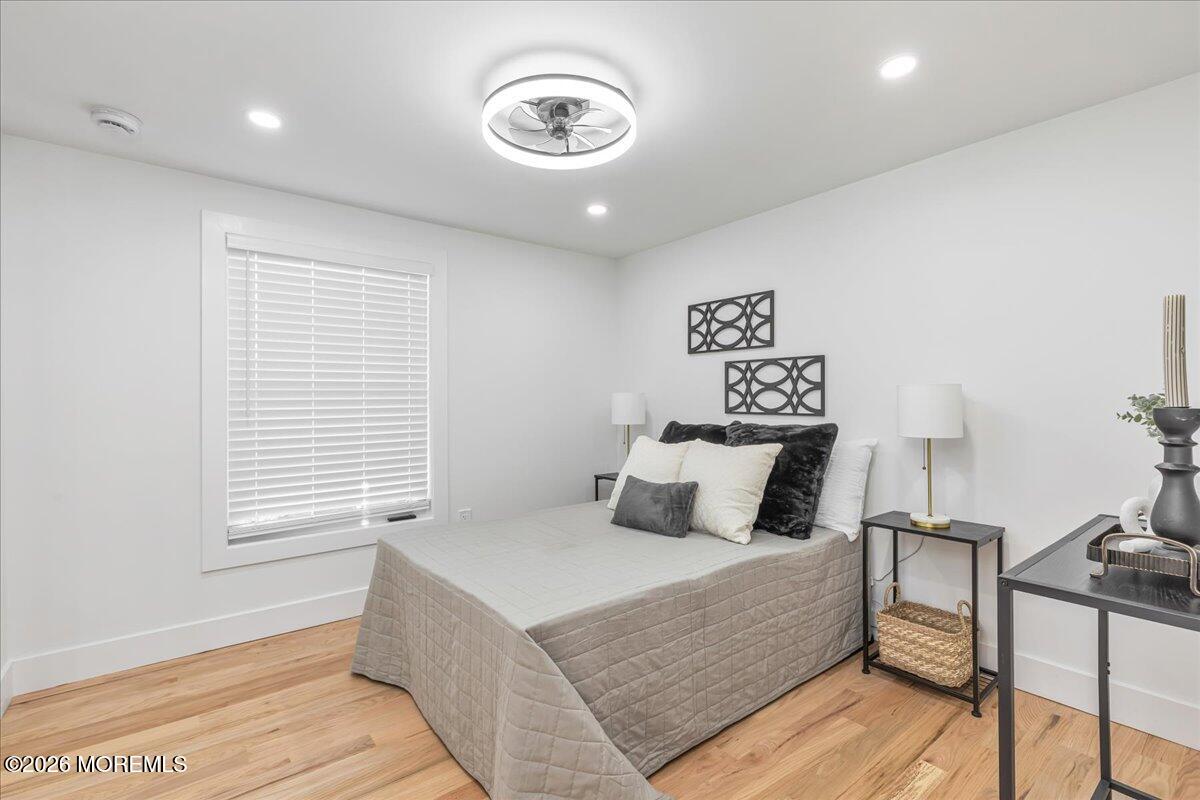 58 Locust Grove Hazlet, NJ 07730 - Photo 16 of 30 a bedroom with a large bed and a chandelier