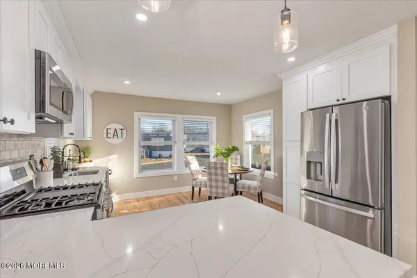 a kitchen with stainless steel appliances a refrigerator and a stove top oven