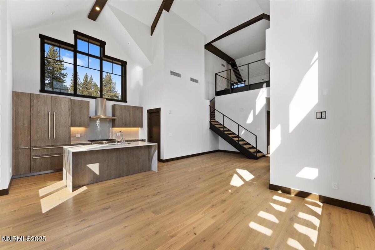 a kitchen with stainless steel appliances granite countertop a refrigerator and a stove