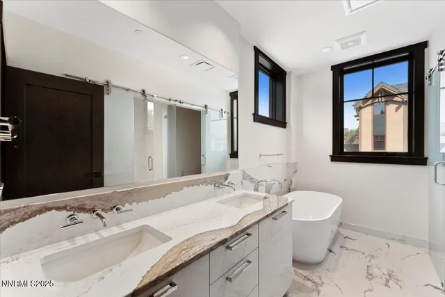 a bathroom with a granite countertop sink toilet and mirror