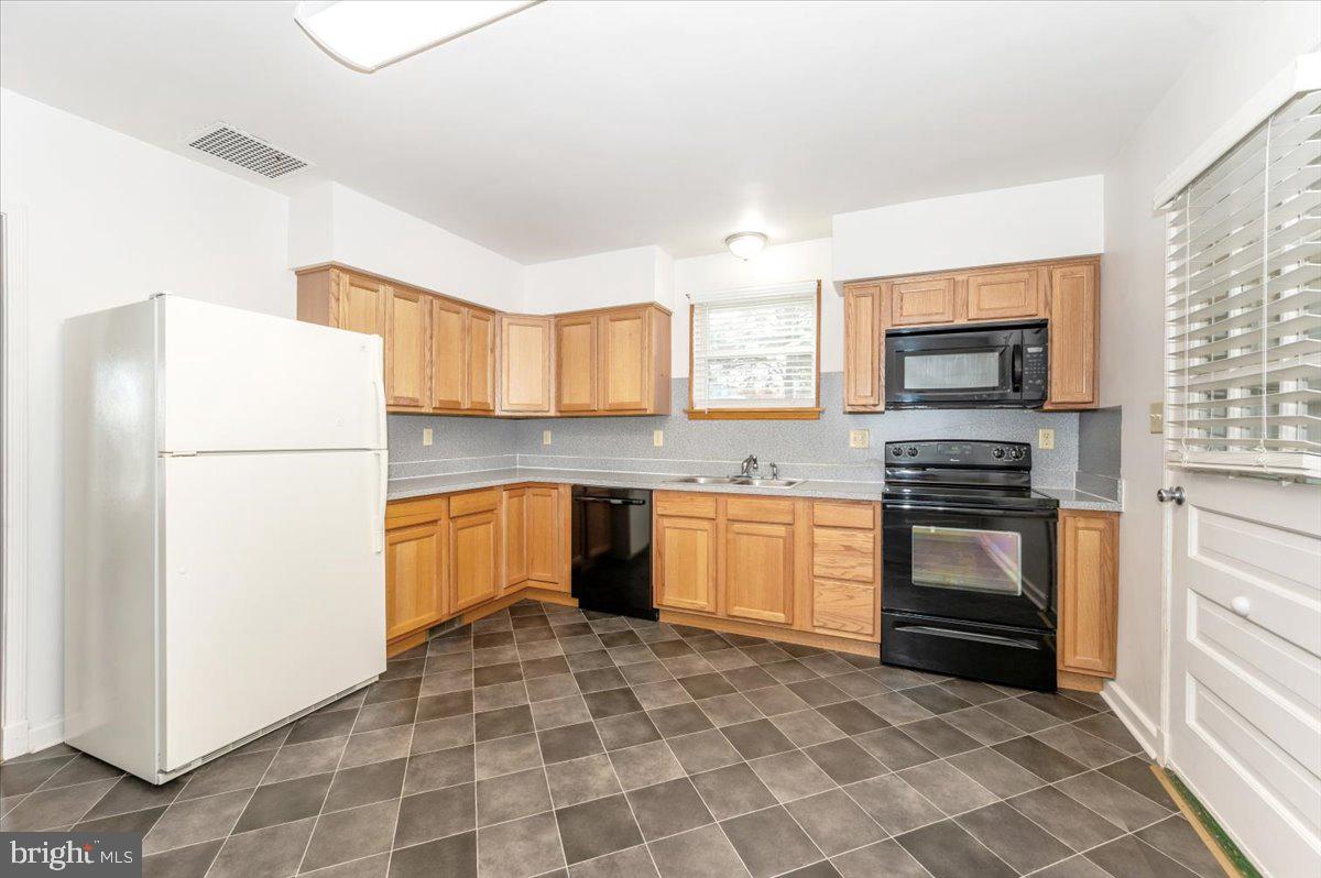 12514 Creagerstown Road Thurmont, MD 21788 - Photo 13 of 57 a kitchen with granite countertop a refrigerator stove top oven and sink