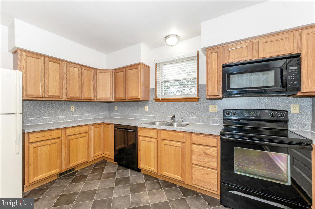 12514 Creagerstown Road Thurmont, MD 21788 - Photo 14 of 57 a kitchen with granite countertop a stove microwave and sink