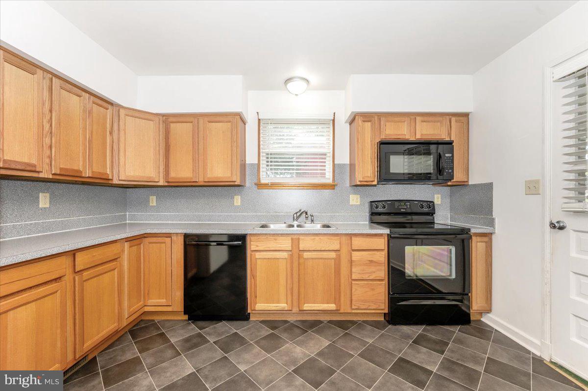 12514 Creagerstown Road Thurmont, MD 21788 - Photo 15 of 57 a kitchen with stainless steel appliances granite countertop a stove a sink and a microwave