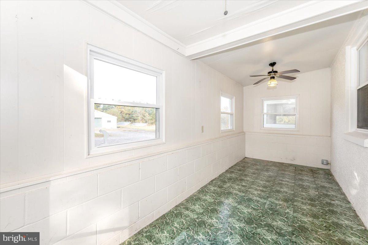 12514 Creagerstown Road Thurmont, MD 21788 - Photo 18 of 57 an empty room with a window and a ceiling fan