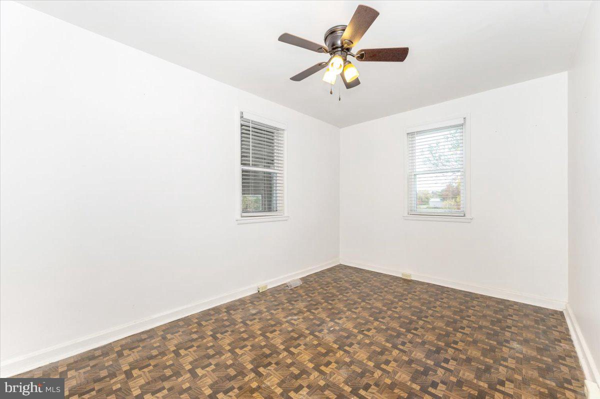 12514 Creagerstown Road Thurmont, MD 21788 - Photo 20 of 57 a view of a big room with wooden floor and a ceiling fan