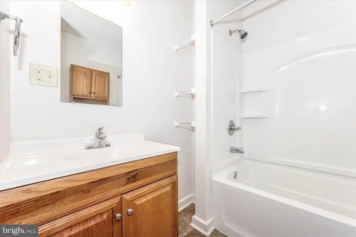 12514 Creagerstown Road Thurmont, MD 21788 - Photo 24 of 57 a bathroom with a bathtub a sink and a shower