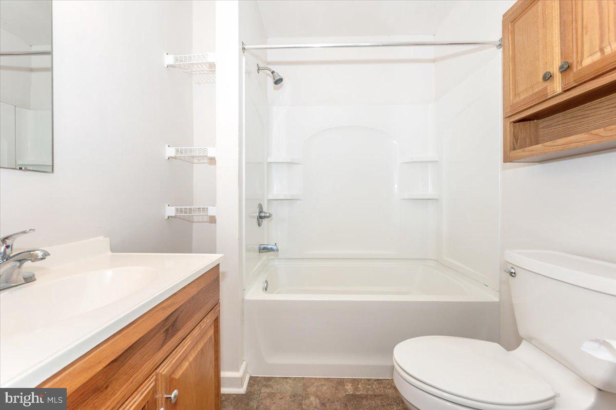 12514 Creagerstown Road Thurmont, MD 21788 - Photo 25 of 57 a bathroom with a sink a toilet and a bathtub