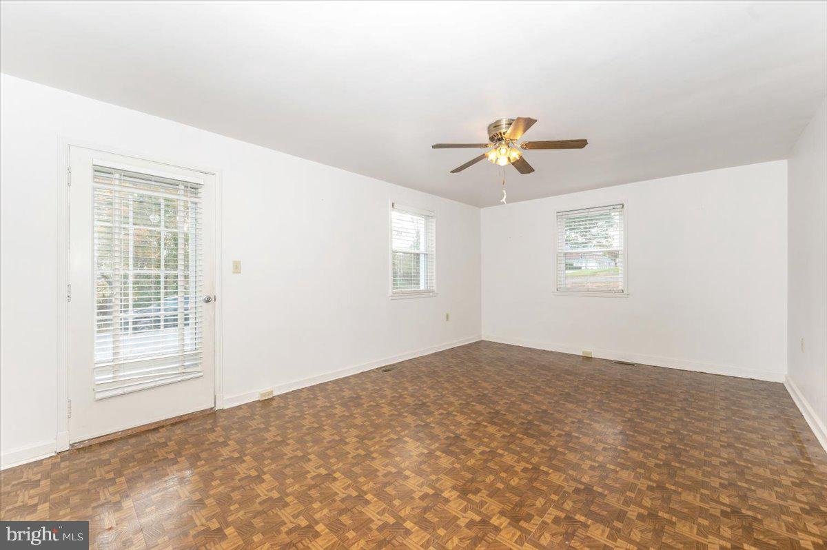 12514 Creagerstown Road Thurmont, MD 21788 - Photo 3 of 57 an empty room with windows and a ceiling fan