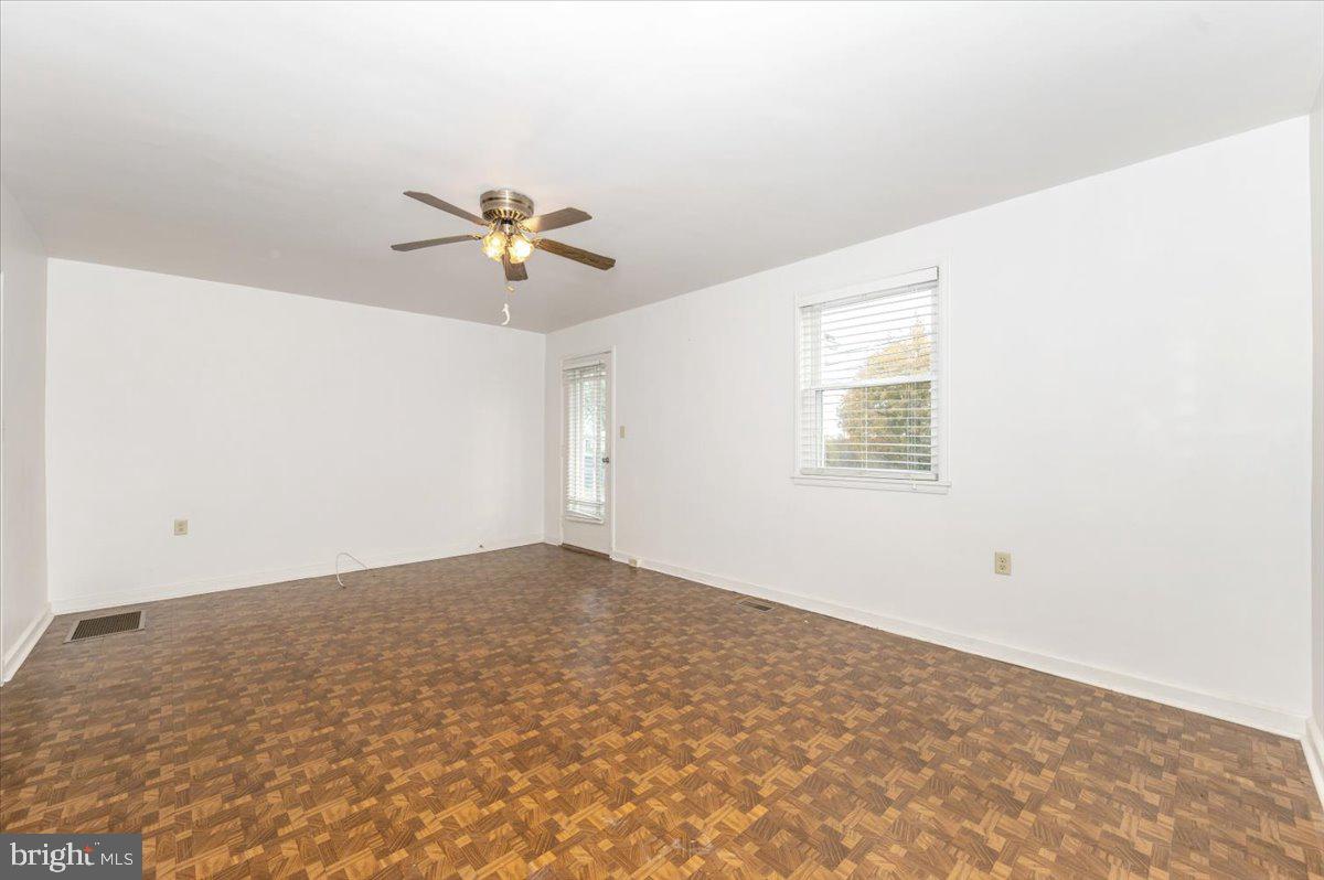 12514 Creagerstown Road Thurmont, MD 21788 - Photo 4 of 57 an empty room with a window and a ceiling fan