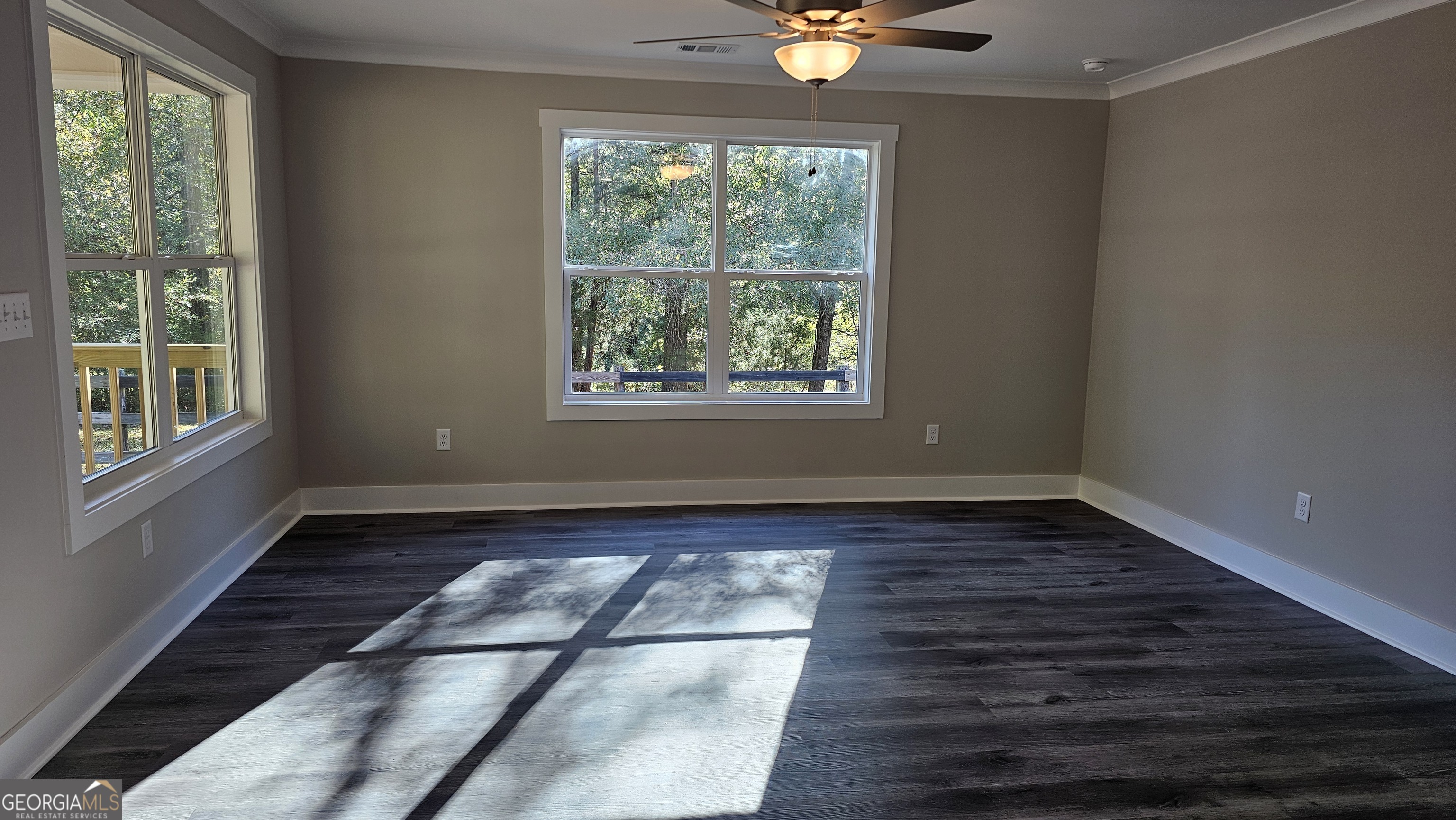 128 Sunset Drive Eatonton, GA 31024 - Photo 5 of 16 a view of an empty room with wooden floor and a window