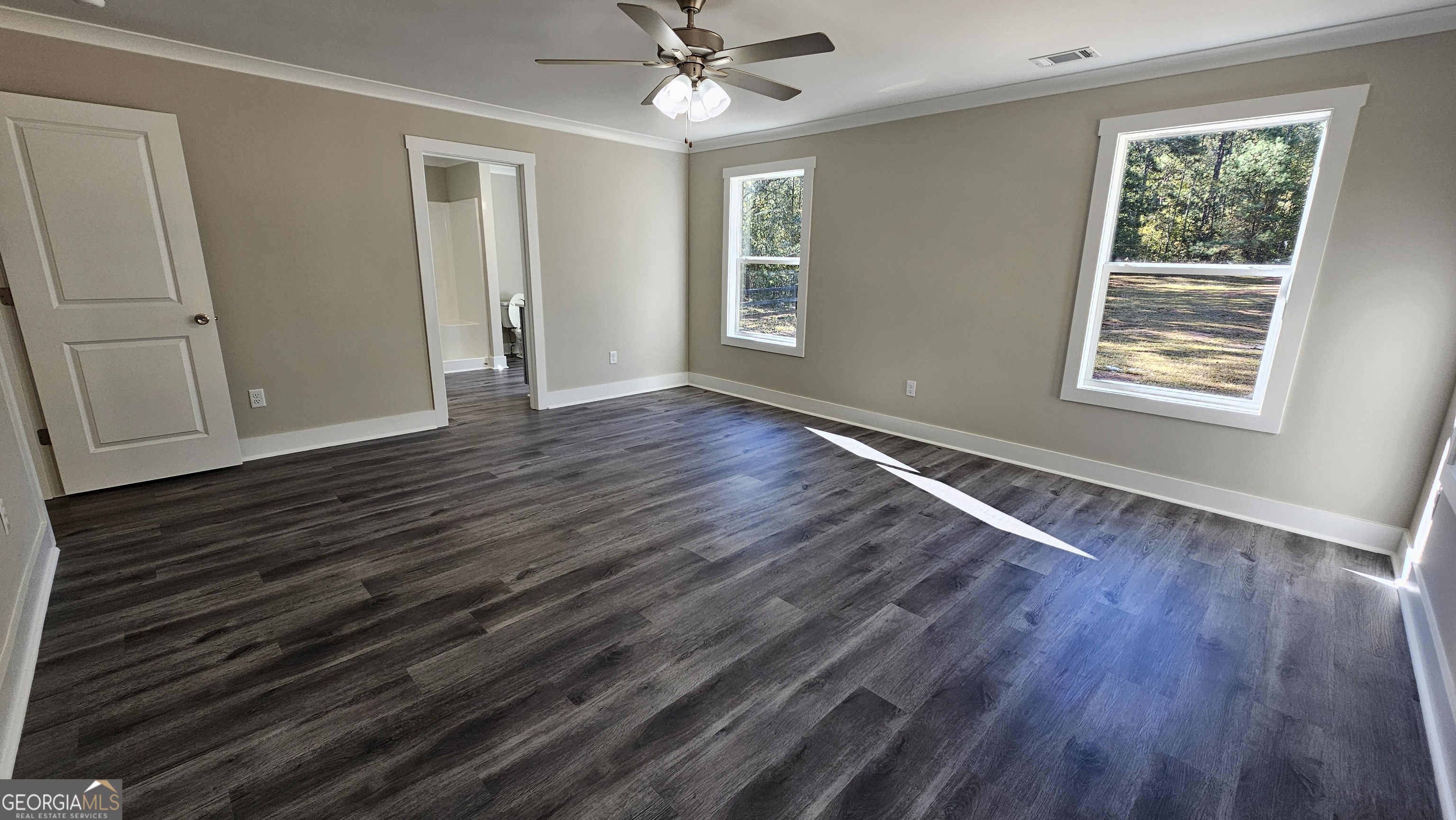 128 Sunset Drive Eatonton, GA 31024 - Photo 8 of 16 a view of an empty room with wooden floor and a window