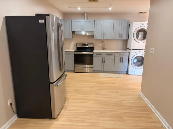 a kitchen with a refrigerator a stove and cabinets