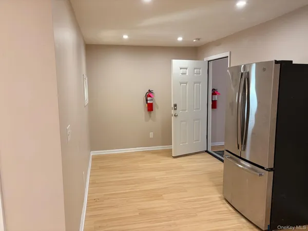 a view of a refrigerator in kitchen and wooden floor