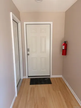 a view of front door with wooden floor