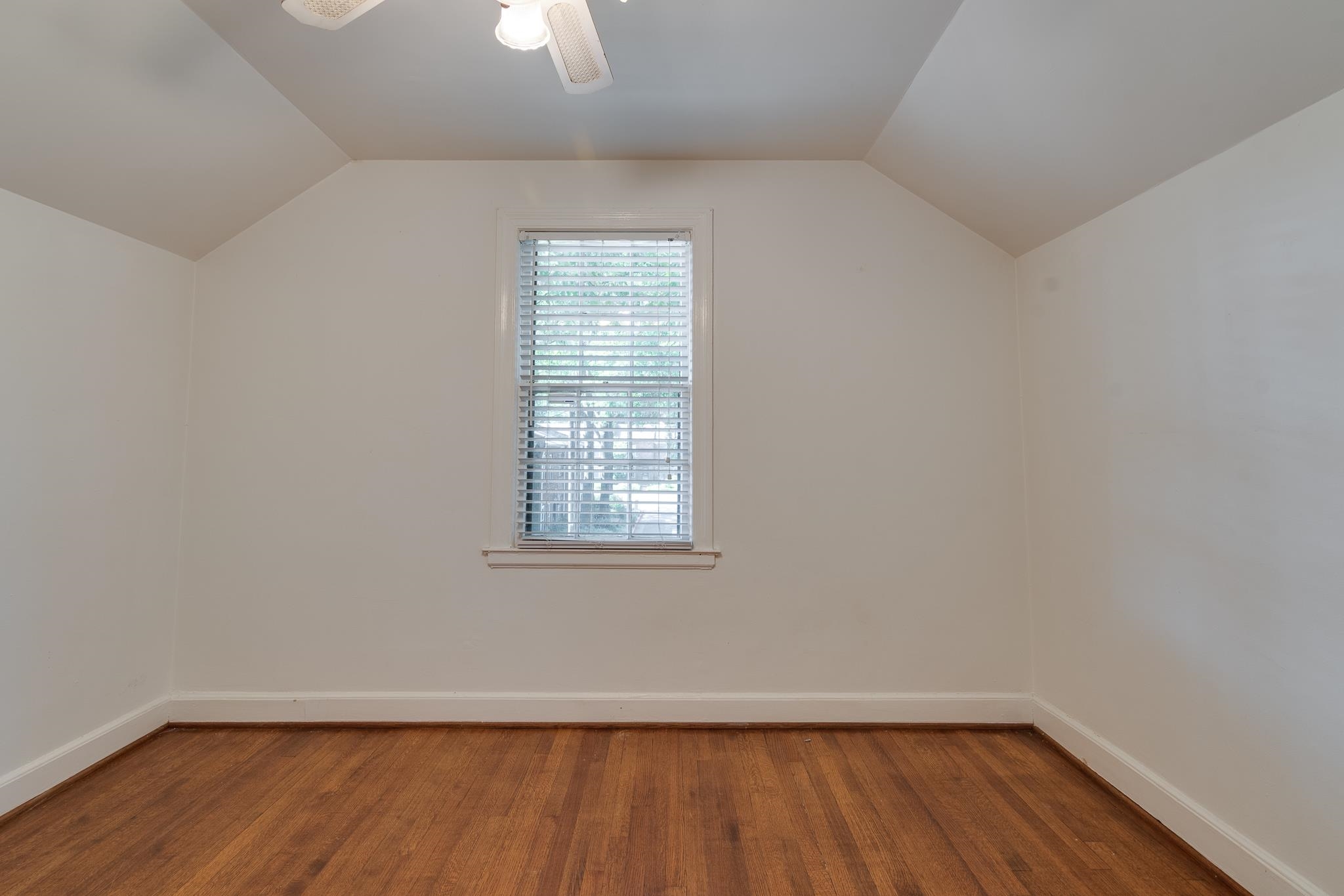 1885 Peabody Avenue, Unit 3 Memphis, TN 38104 - Photo 12 of 30 an empty room with wooden floor cabinet and windows