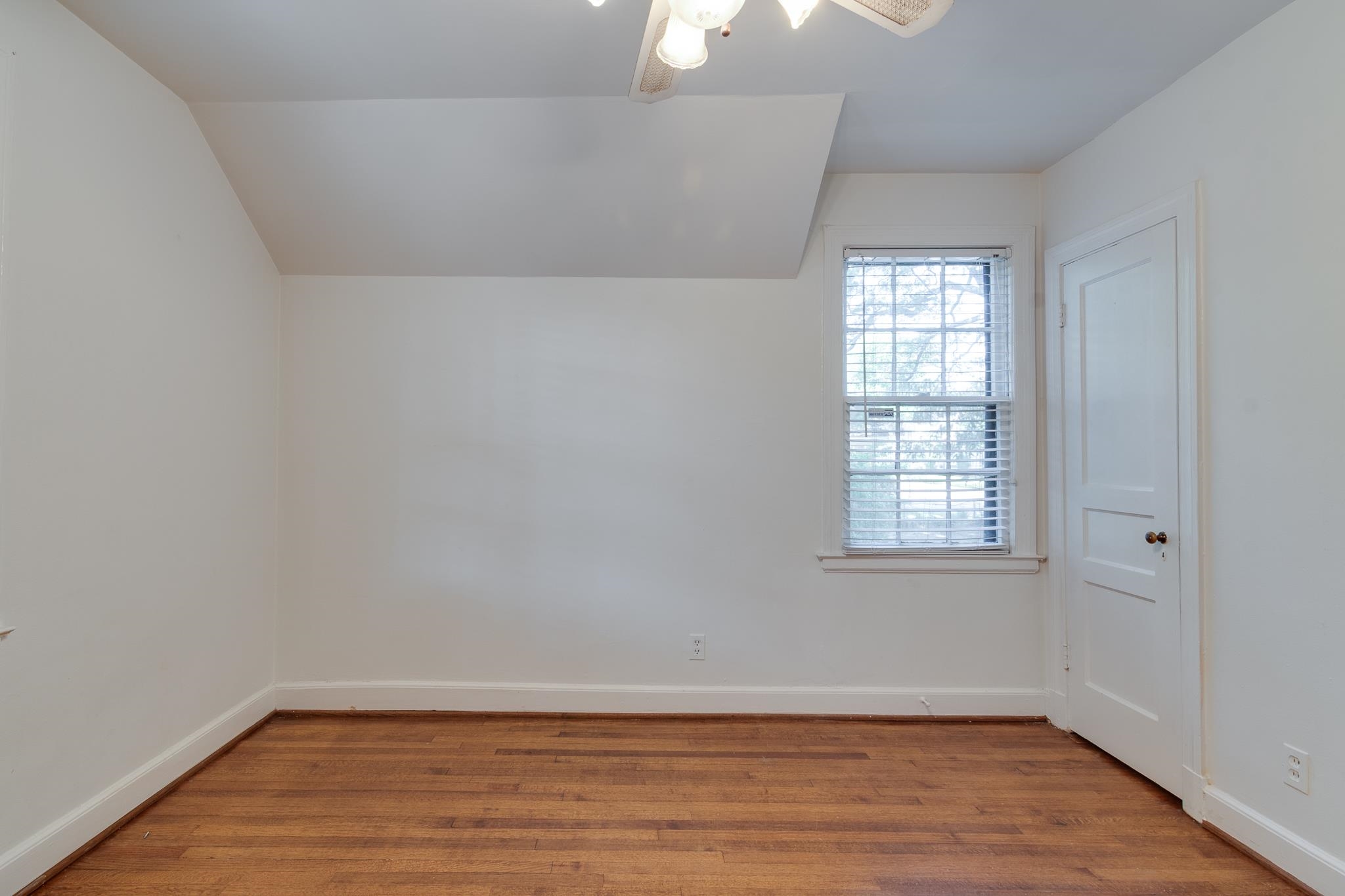 1885 Peabody Avenue, Unit 3 Memphis, TN 38104 - Photo 13 of 30 an empty room with wooden floor and windows