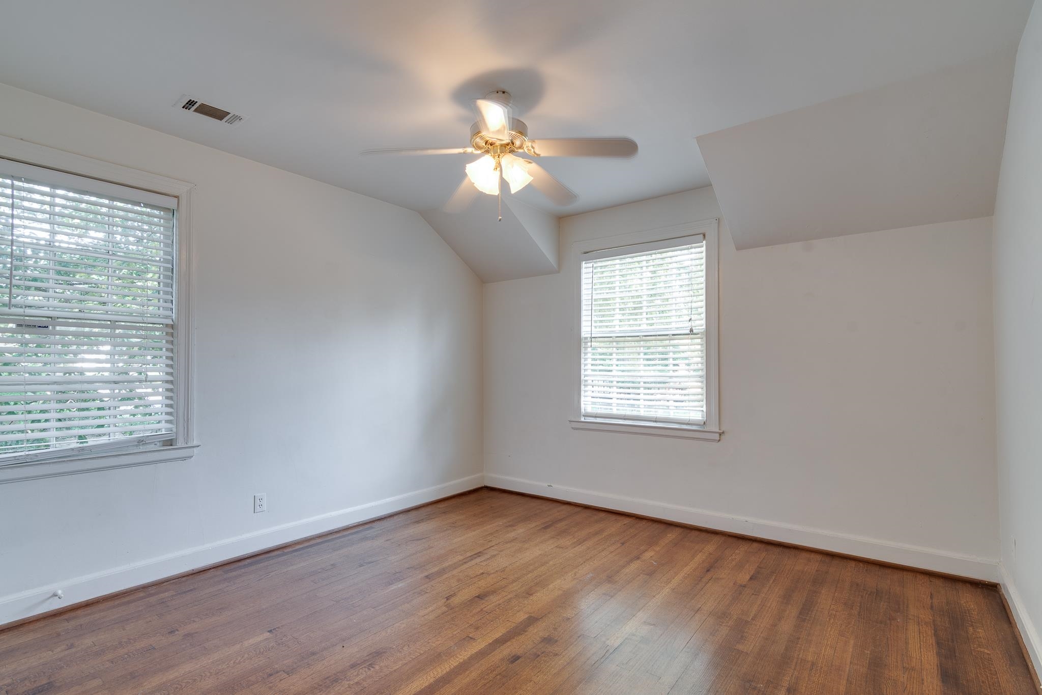 1885 Peabody Avenue, Unit 3 Memphis, TN 38104 - Photo 17 of 30 a view of an empty room with wooden floor and a window