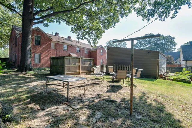 a view of backyard of house with green space