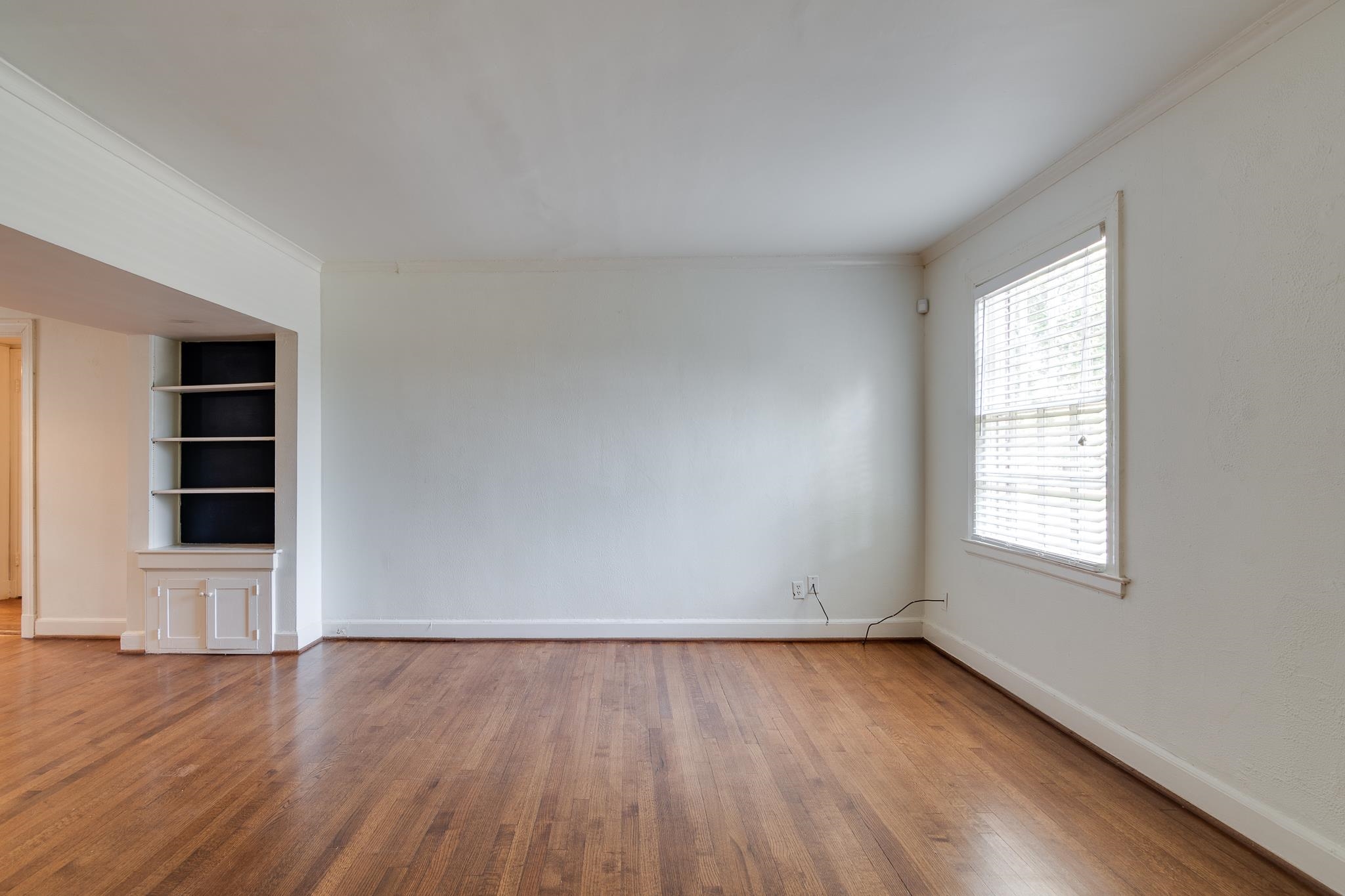 1885 Peabody Avenue, Unit 3 Memphis, TN 38104 - Photo 3 of 30 an empty room with wooden floor and window