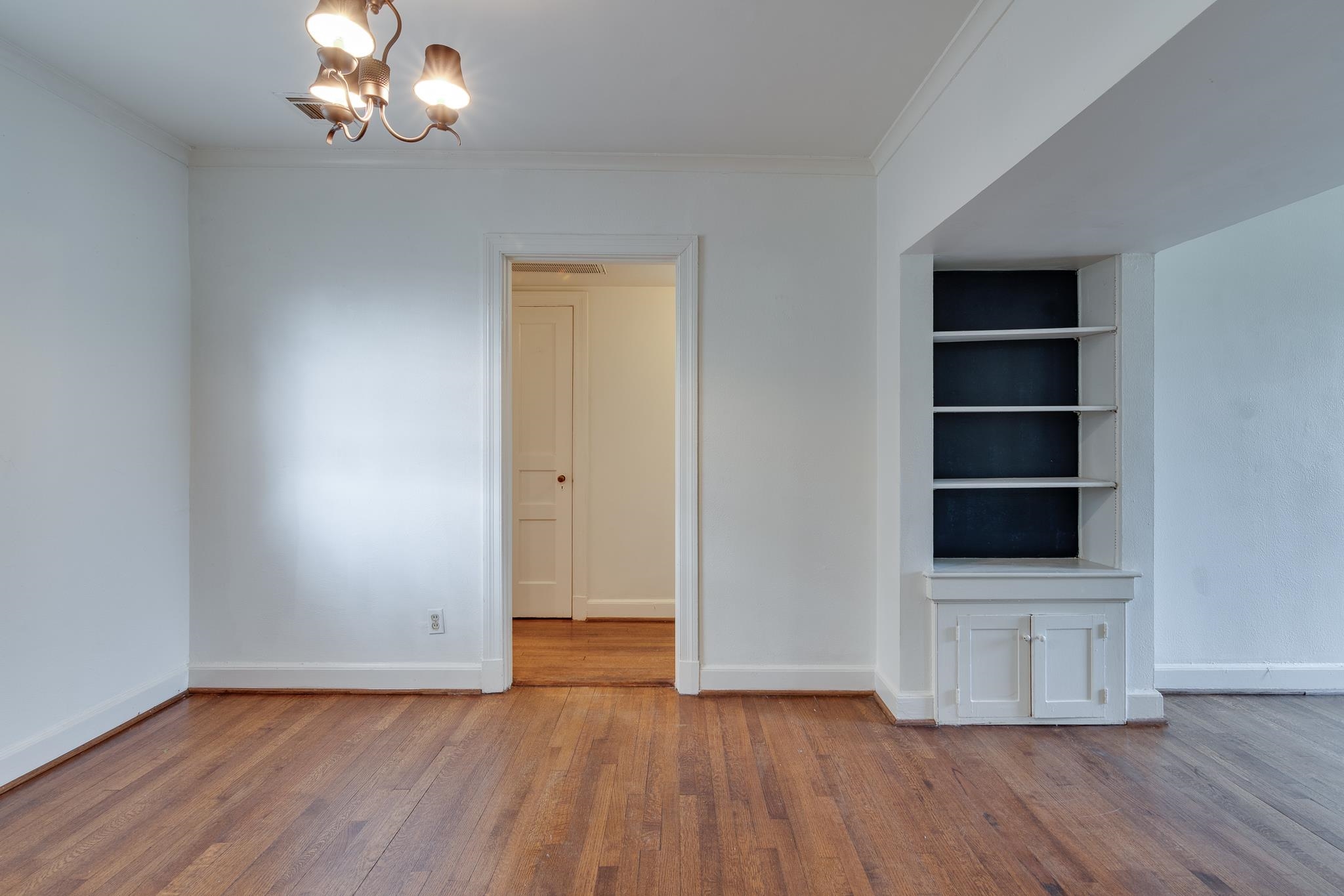 1885 Peabody Avenue, Unit 3 Memphis, TN 38104 - Photo 10 of 30 a view of an empty room with a window and wooden floor