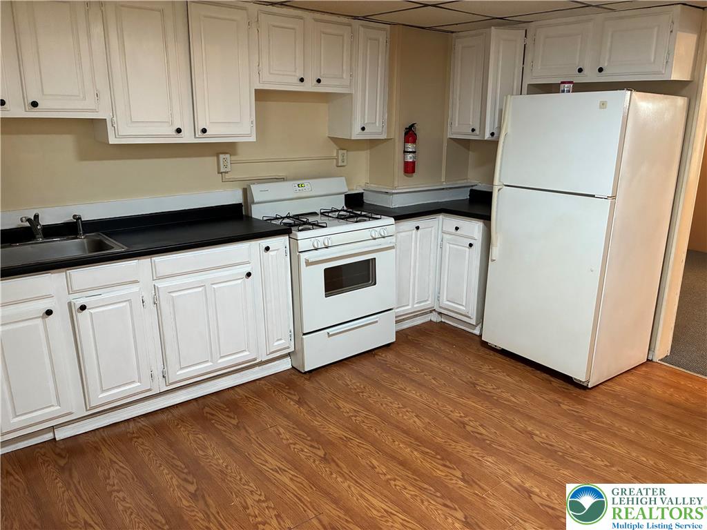 515 Breck Street, Unit 1 Scranton, PA 18505 - Photo 5 of 5 a kitchen with granite countertop white cabinets and white appliances
