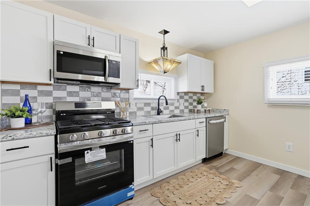 805 Colonial Avenue Monaca, PA 15061 - Photo 11 of 30 a kitchen with stainless steel appliances a stove microwave and sink