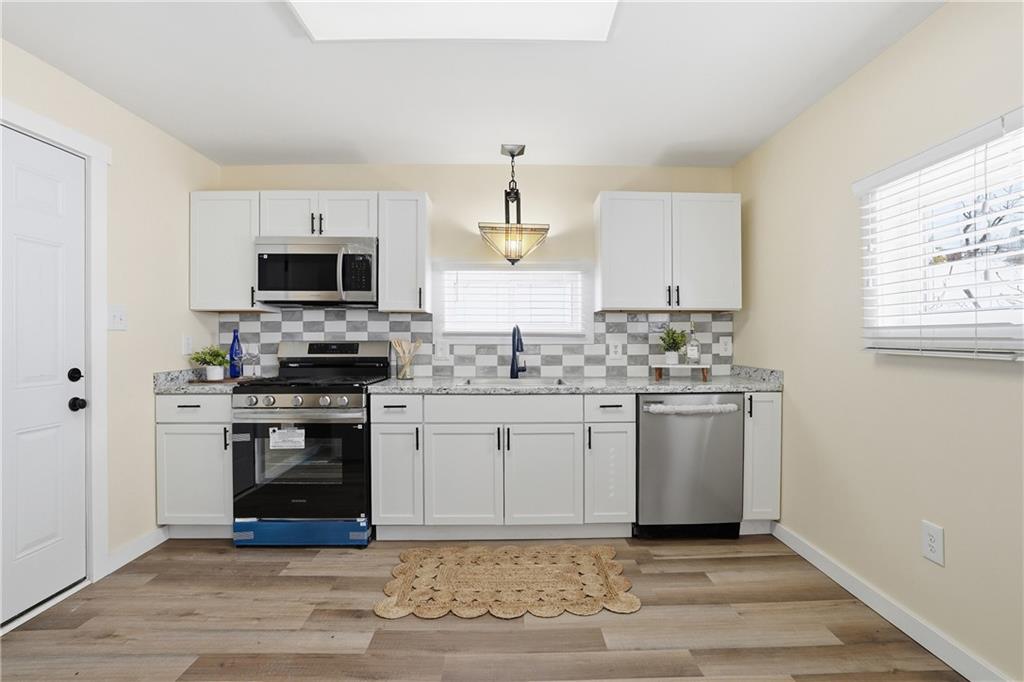 805 Colonial Avenue Monaca, PA 15061 - Photo 12 of 30 a kitchen with stainless steel appliances granite countertop a stove a sink and a microwave