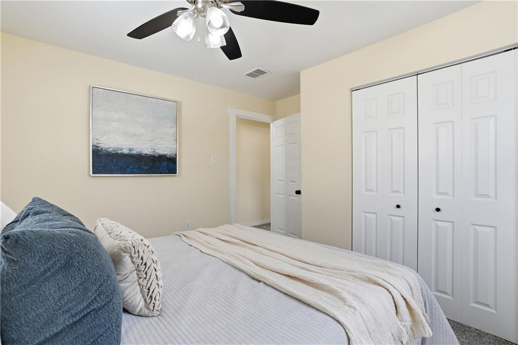 805 Colonial Avenue Monaca, PA 15061 - Photo 20 of 30 a bedroom with a large bed and a chandelier