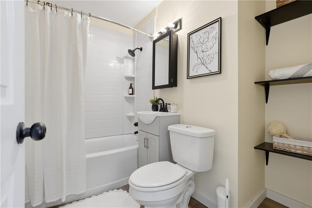 805 Colonial Avenue Monaca, PA 15061 - Photo 24 of 30 a white toilet sitting next to a bathroom sink and tub