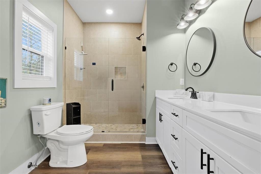 1475 Ben Davis Road Buchanan, GA 30113 - Photo 20 of 61 a bathroom with a double vanity sink mirror bathtub and toilet