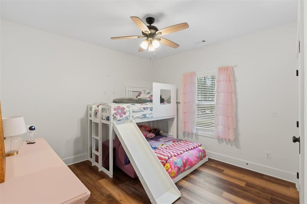 1475 Ben Davis Road Buchanan, GA 30113 - Photo 22 of 61 a bedroom with a bed and a chandelier