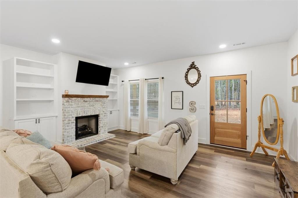 1475 Ben Davis Road Buchanan, GA 30113 - Photo 5 of 61 a living room with furniture a fireplace and a flat screen tv