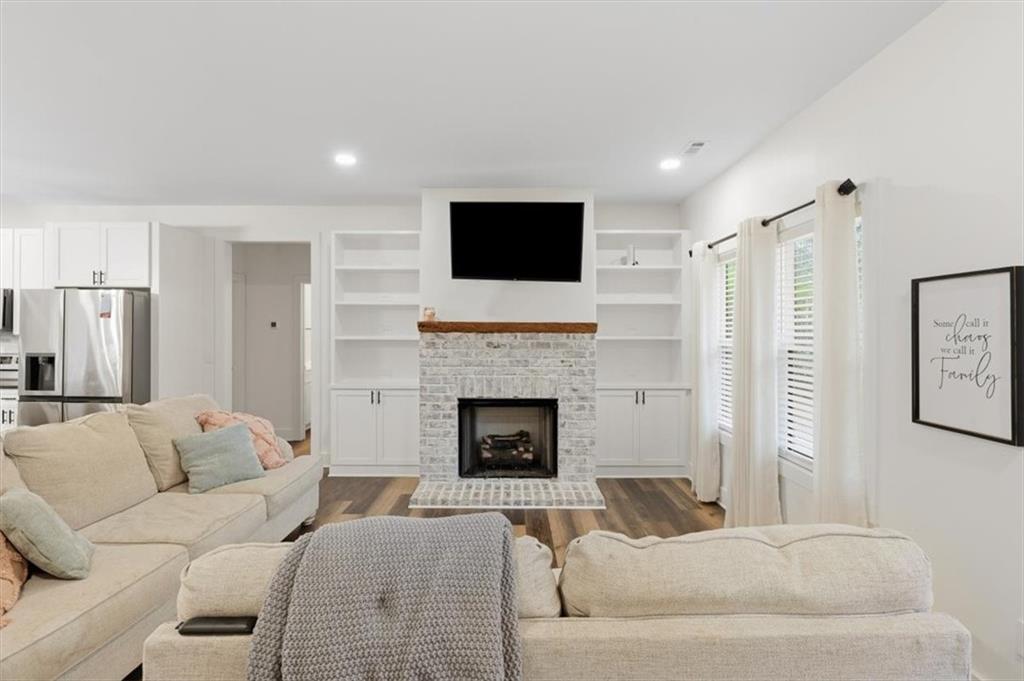 1475 Ben Davis Road Buchanan, GA 30113 - Photo 8 of 61 a living room with furniture a flat screen tv and a fireplace