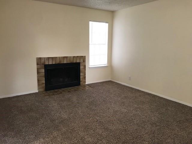 4748 Old Bent Tree Lane, Unit 803 Dallas, TX 75287 - Photo 3 of 20 an empty room with a fireplace