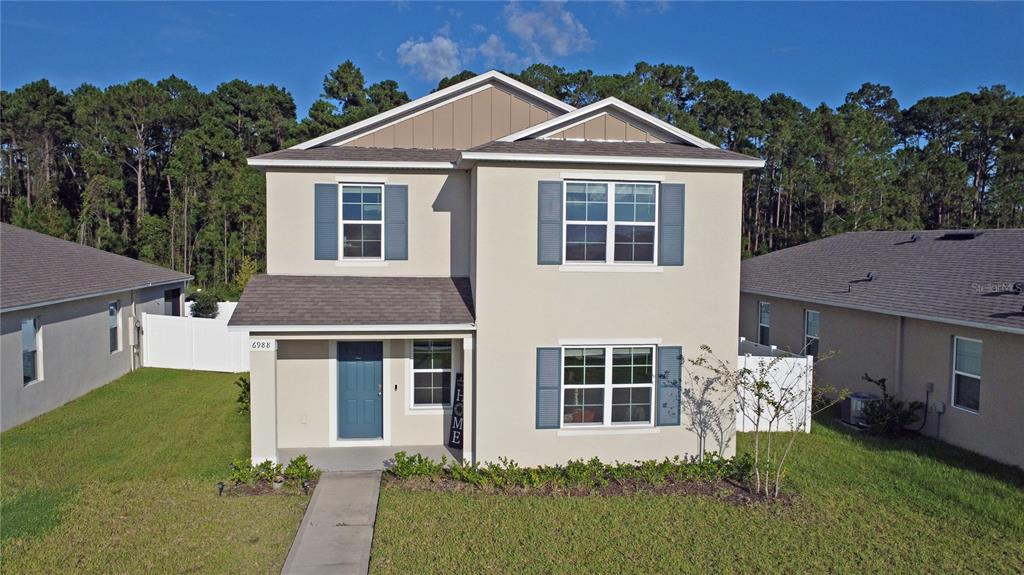a front view of a house with a yard